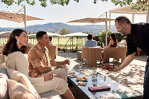 Pouring wine for two visitors on the oak terrace